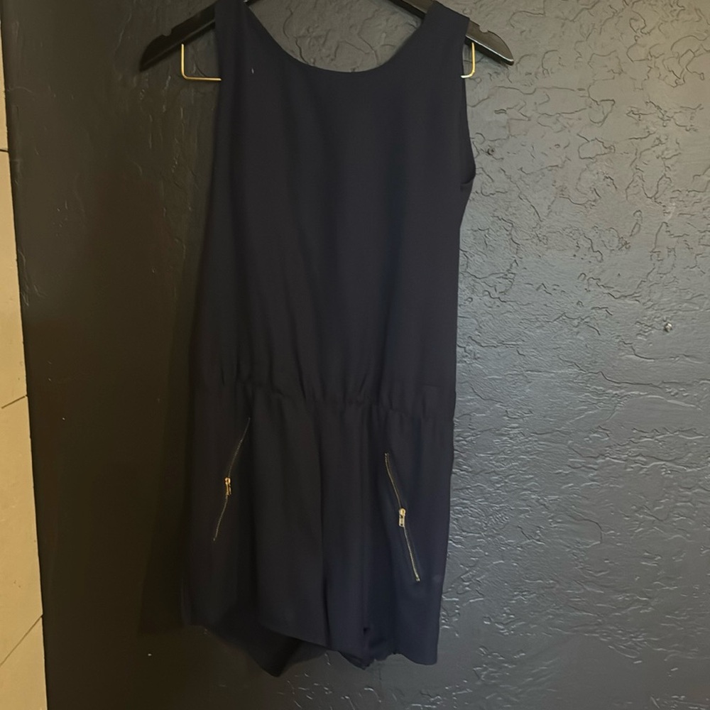 blue romper with zippers on pockets